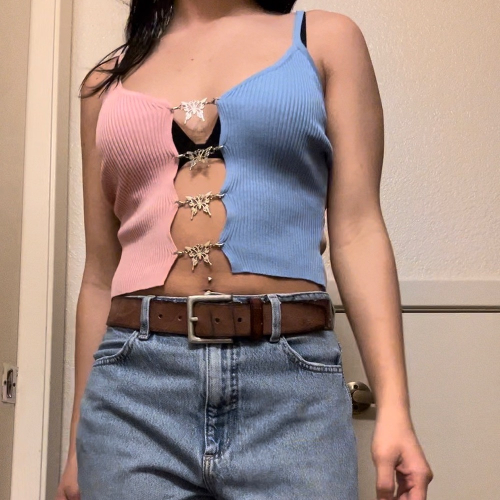 Open-bust blue, pink, and tan crop top with butterfly clips